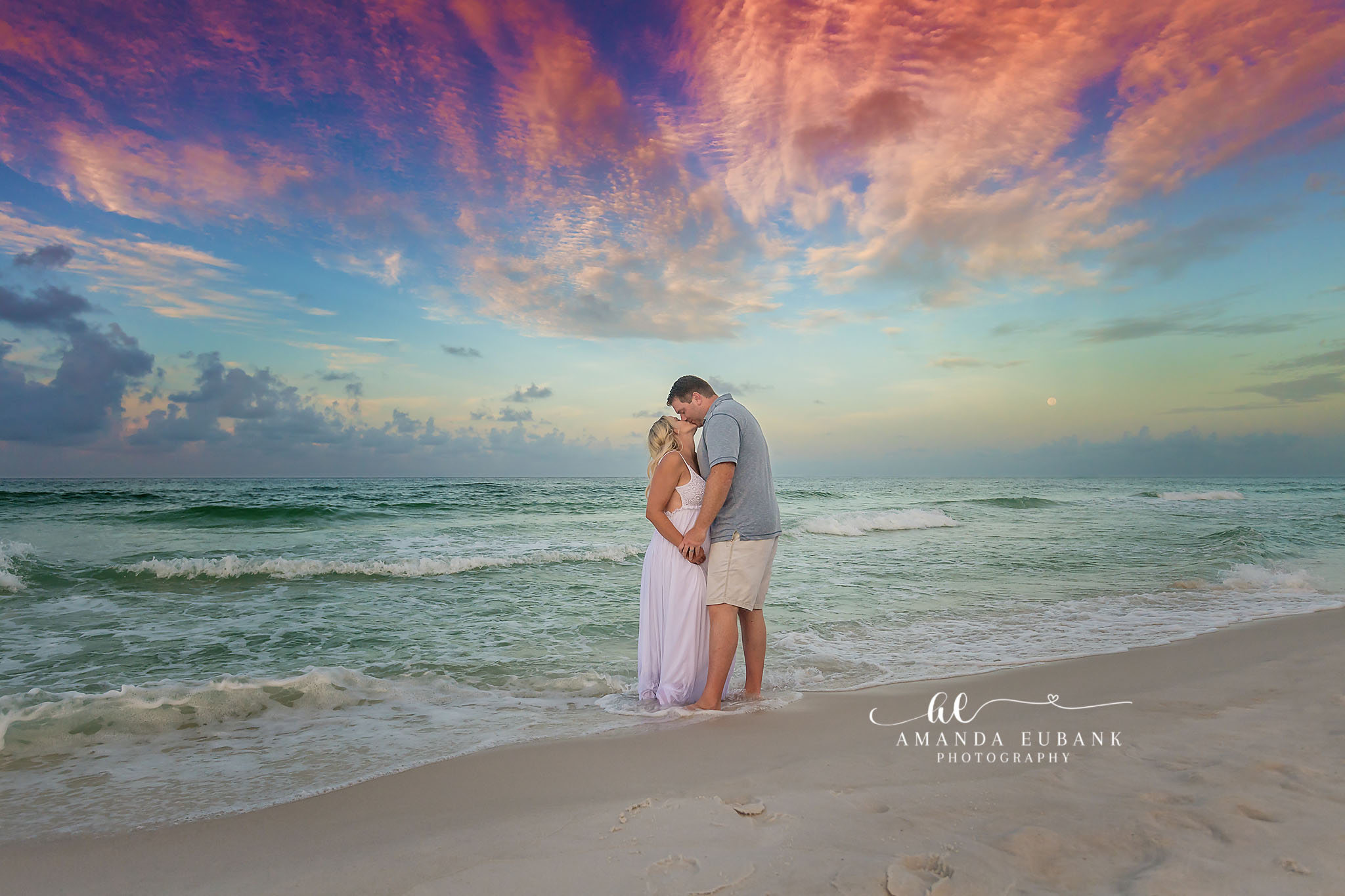 Romantic Beach Engagement Session in Seaside Florida at Sunset Seaside engagement photographer captures couple embracing at sunset on the beach
