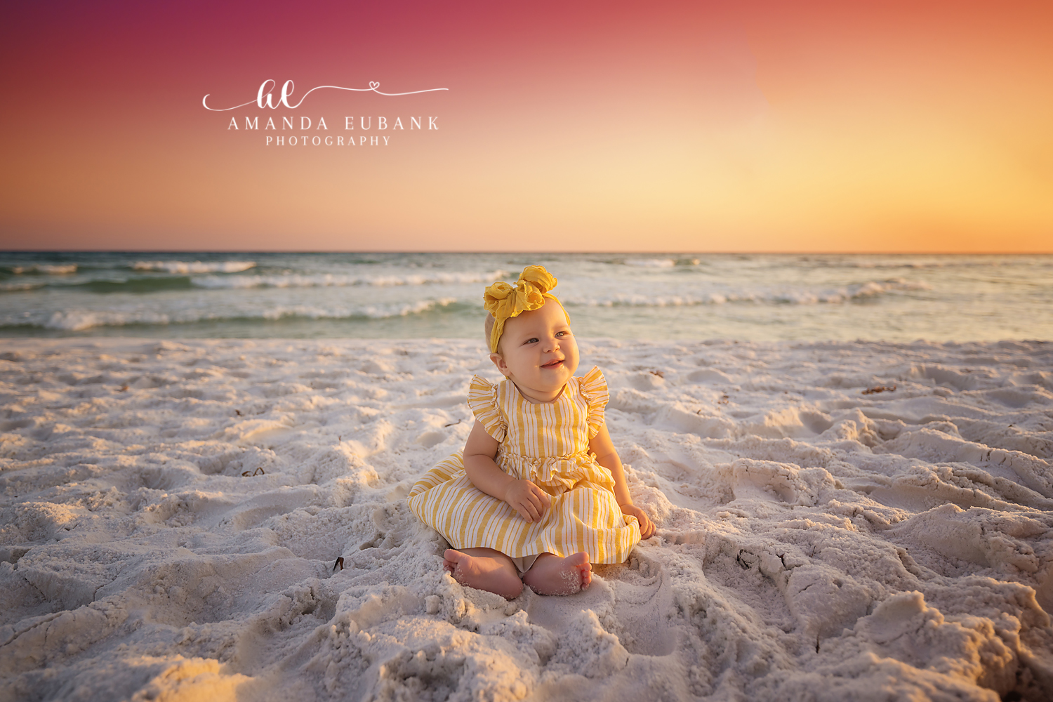 Family together on the beach smiling at sunset in Seaside Florida