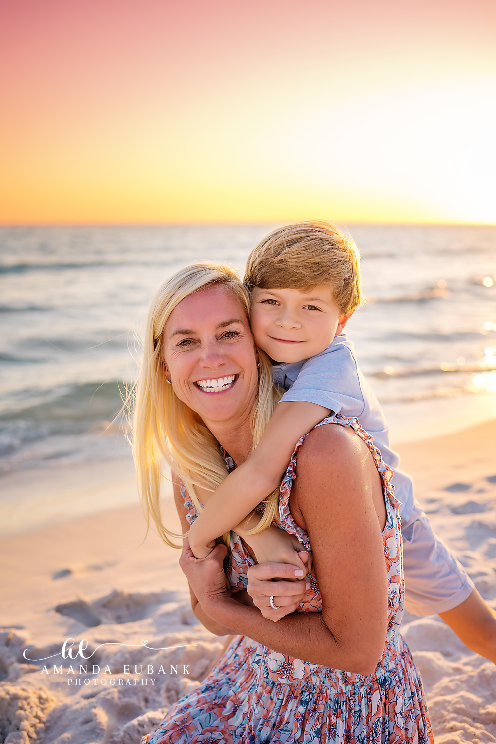Family posing together on the beach with a sunset sky in Seaside Florida