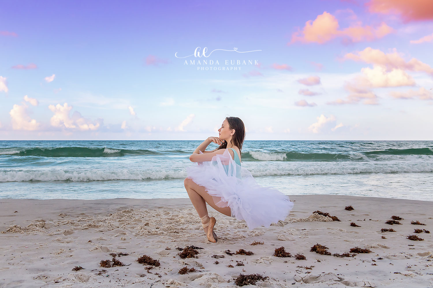 Seaside senior photographer captures ballerina senior in white tutu posing on the beach