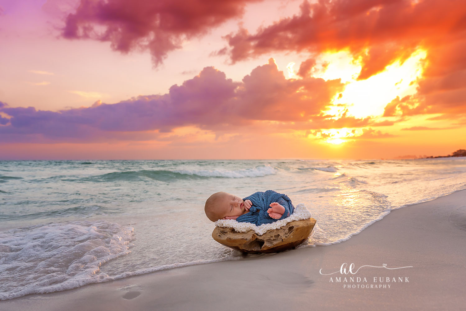 Seaside Newborn Photography | Golden Hour Beach Portrait Beautiful Seaside Florida newborn portrait of baby sleeping on the beach surrounded by soft pastel clouds