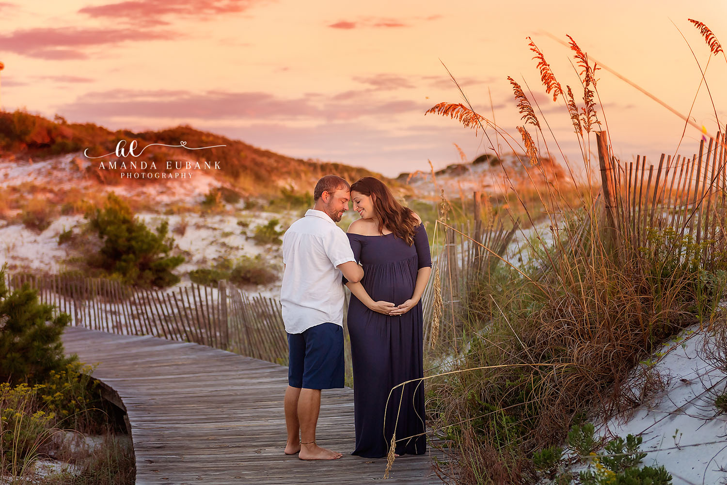 Expecting mother in a flowing lace gown captured during a Seaside Florida outdoor maternity session