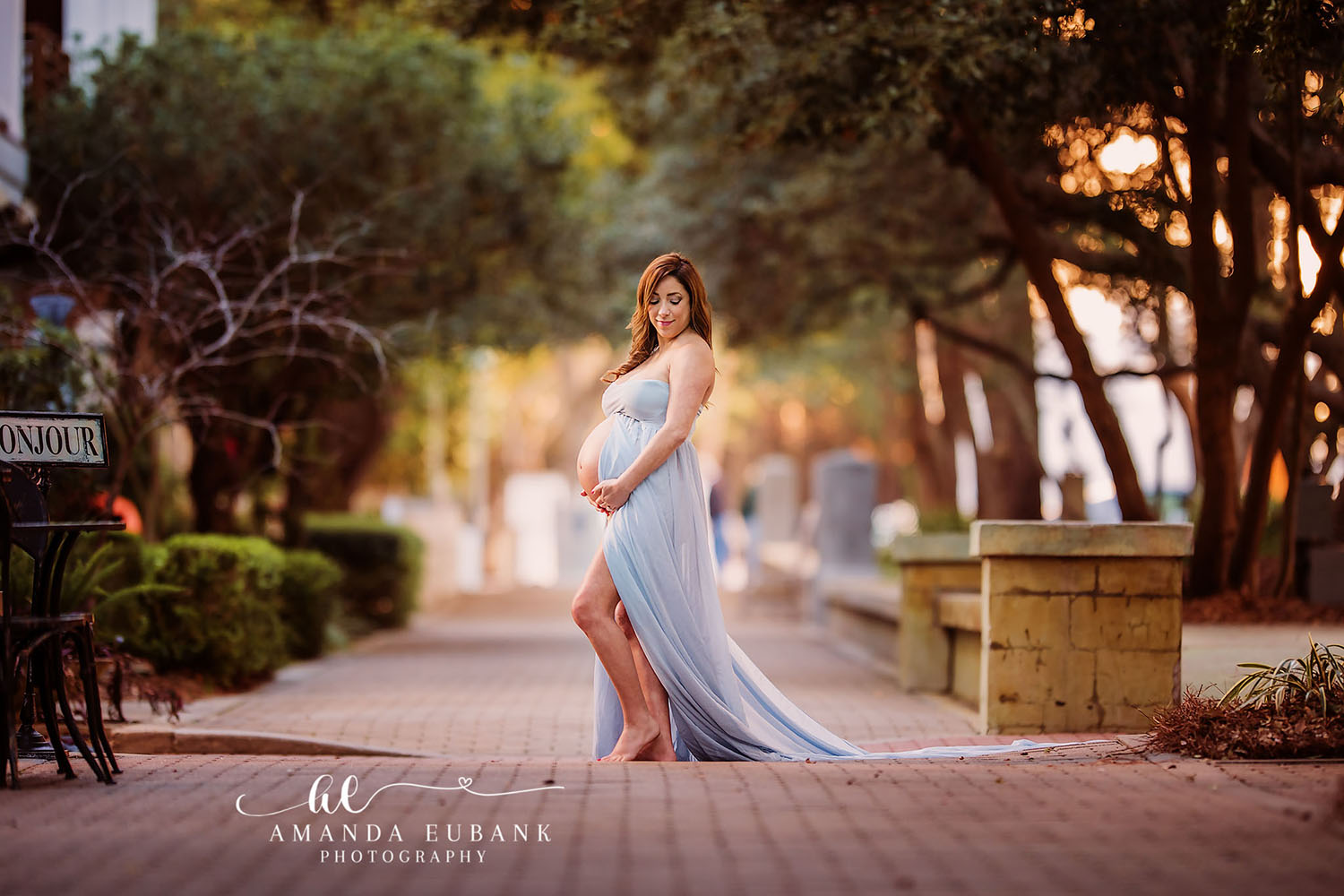Expecting mother in a beautiful gown during a Seaside FL maternity session in a lush wooded setting