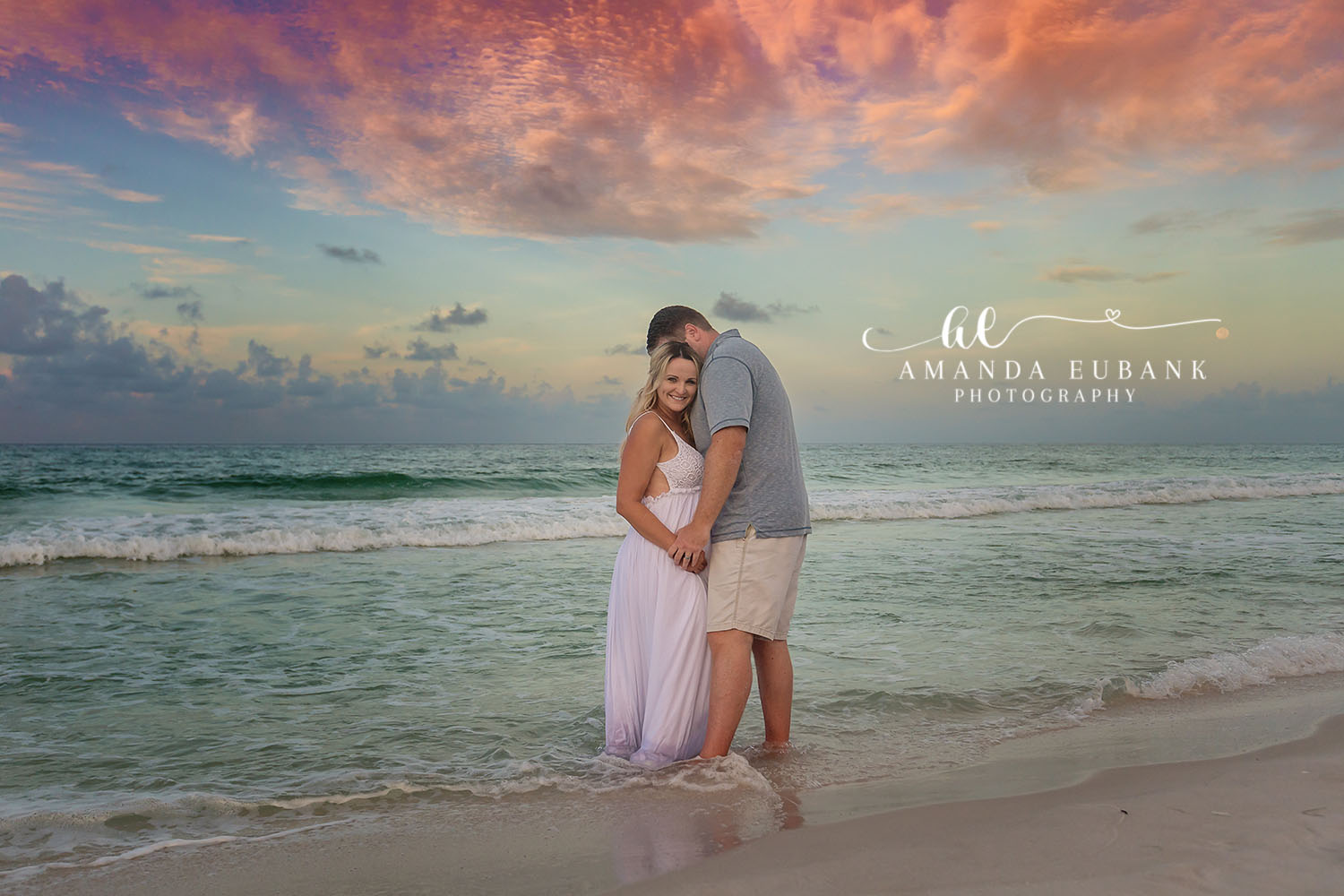 Seaside maternity photographer photographs expecting couple in soft natural light along the Gulf Coast