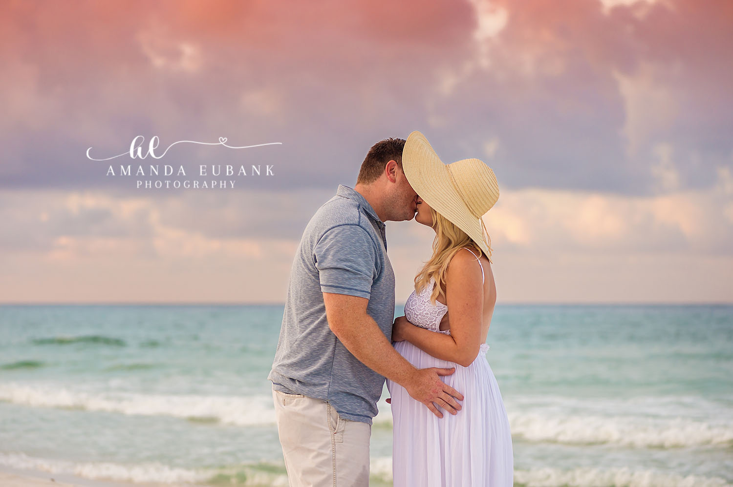 Beautiful maternity portrait of expecting mother at golden hour on Seaside Florida's sugar-white sand beach