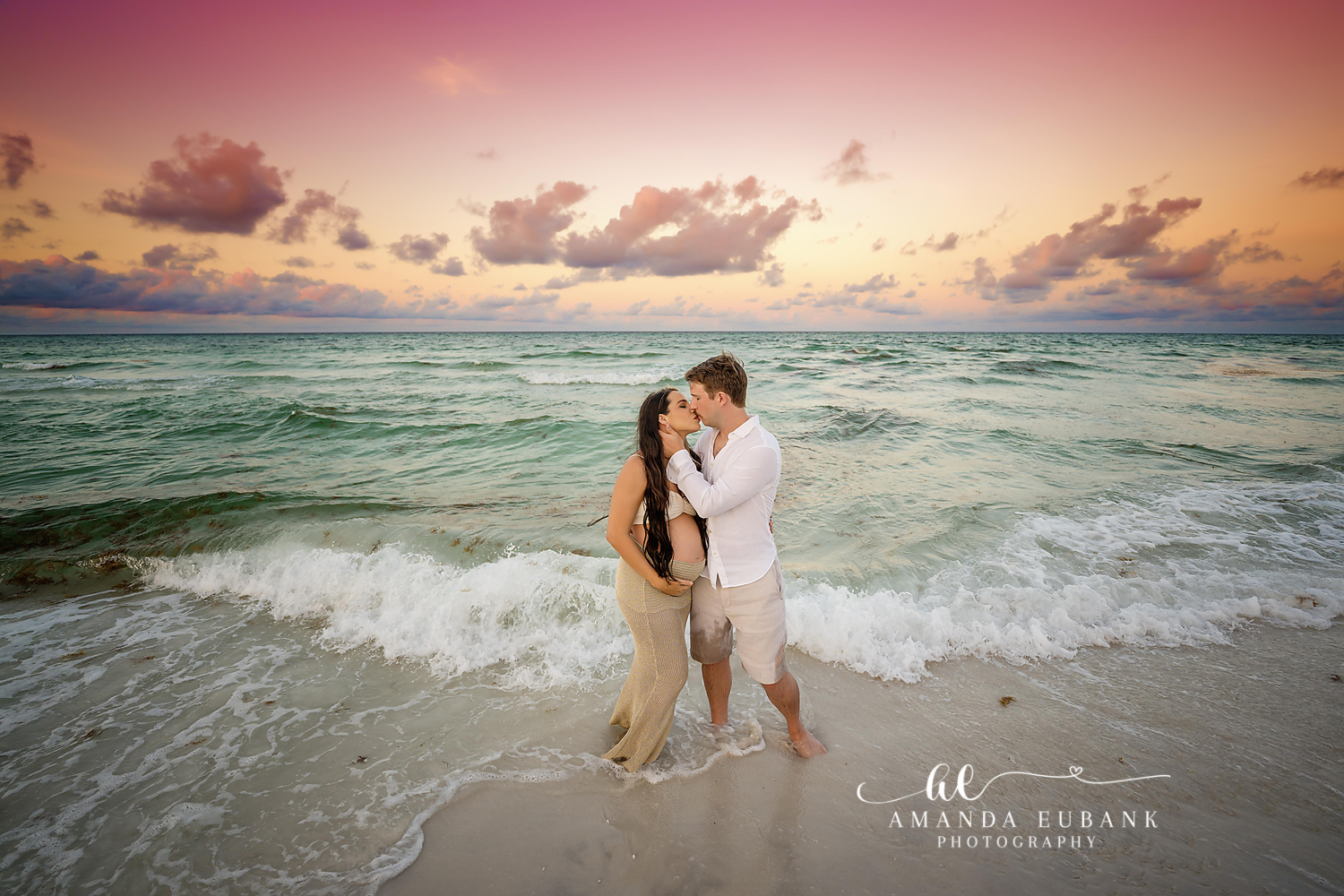 Expecting mother in elegant gown during a Seaside Florida maternity portrait session at sunset