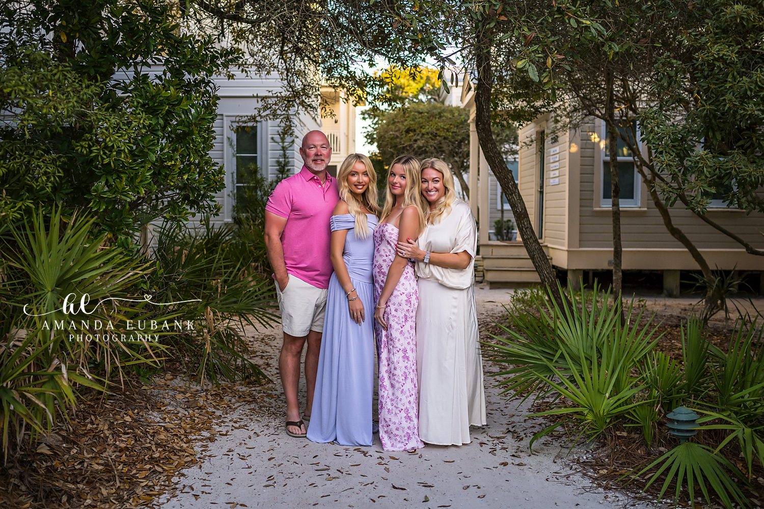 Senior Portrait of Young Woman Blue Maxi Dress at Seaside Florida Beach at Colorful Sunset Senior girl with dark wavy hair in a flowing blue maxi dress at the beach at a vivid multicolored sunset sky in Seaside Florida